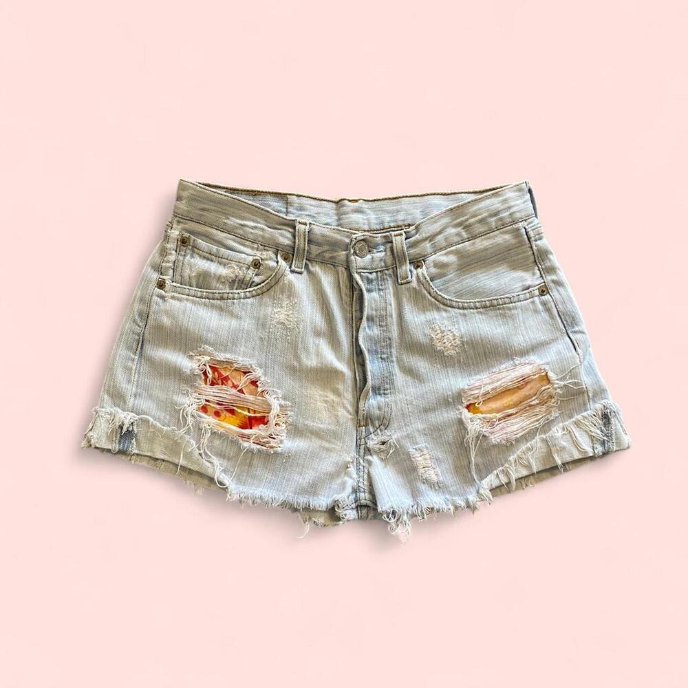 Vintage Levi’s distressed denim shorts with floral pattern